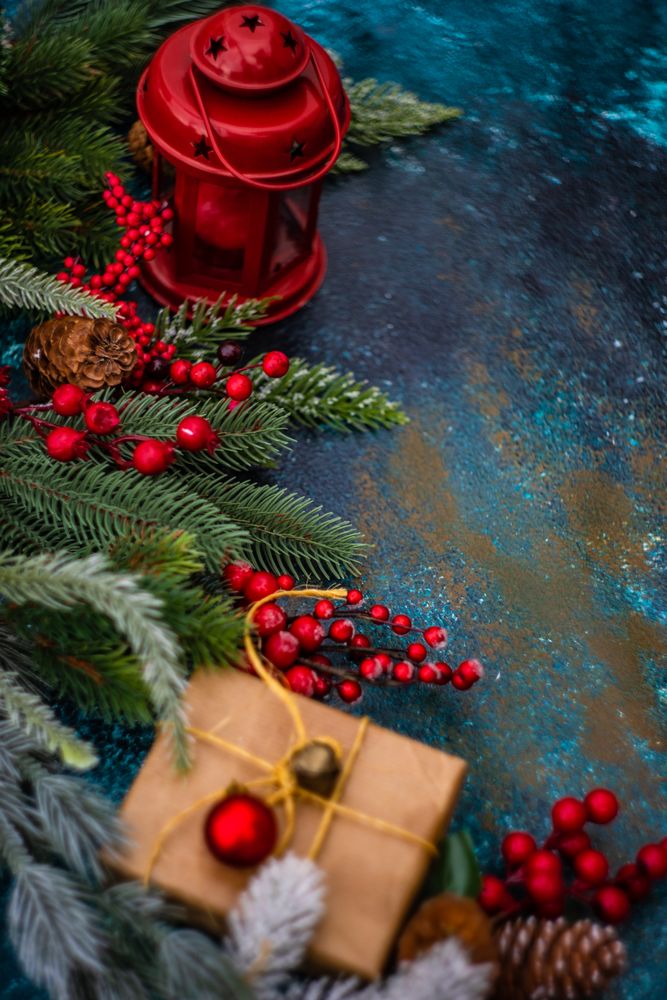 Table with fir, holly, pine and wrapped Christmas gift and decorations