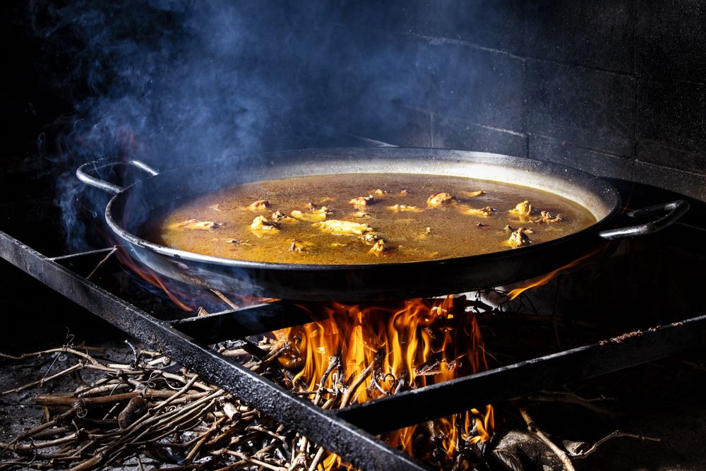 Process of cooking paella on fire