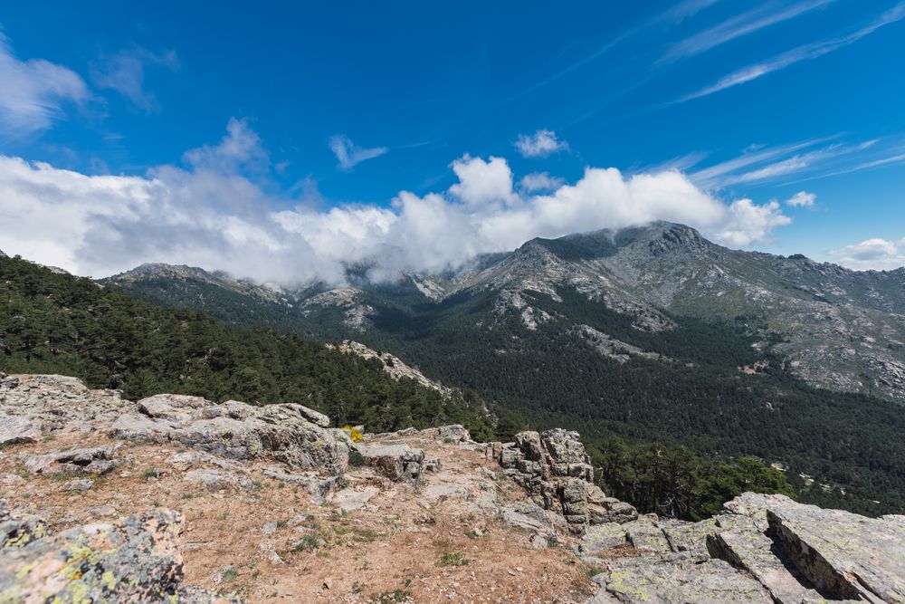 Breathtaking white clouds above hills with greenery