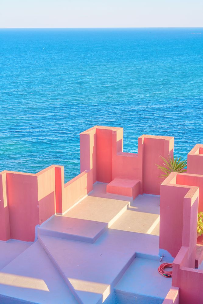 Pink wall construction against blue sea