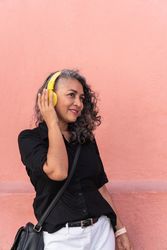 Mature Woman Listening To Music And Dancing
