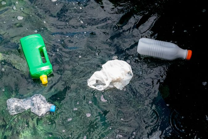 Plastic bottles and bag floating on water