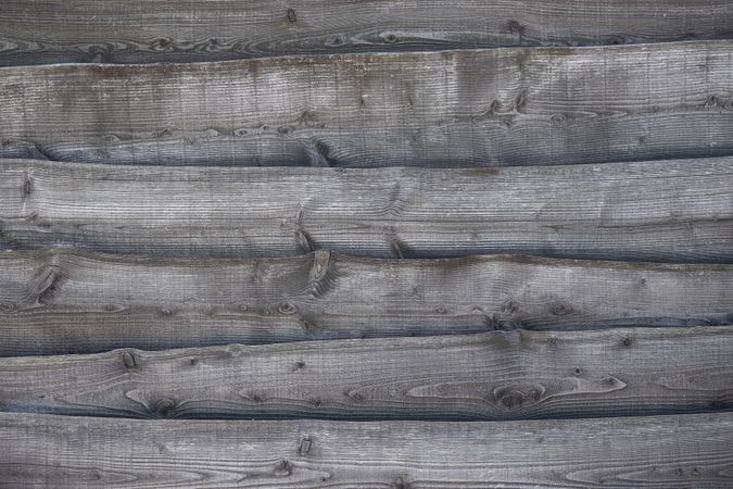 Full frame image of a rustic grey wooden background with horizontal lines with space for copy