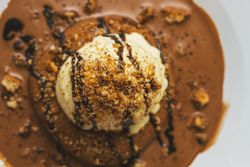 Tasty sweet burger with chocolate crumb and nuts