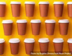 Three rows of disposable coffee cups on yellow background 47Mya0