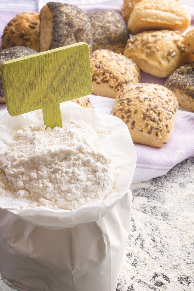 Open flour bag with blank wooden banner