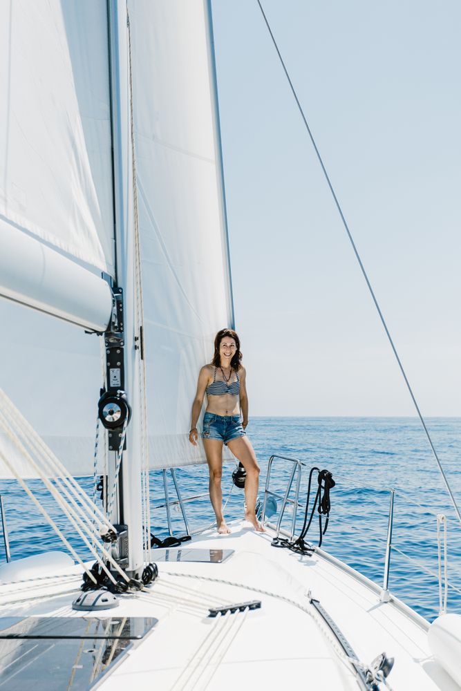 Woman in swimsuit standing on boat