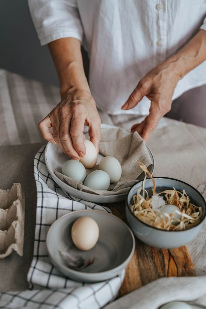 Cropped image of a person cracking an egg