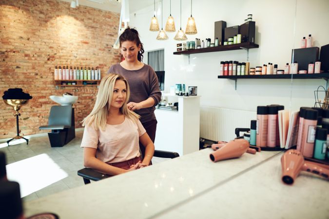 Salon owner giving client’s hair a trim