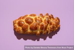 Sliced challah bread top view on a purple background 5wEqZb