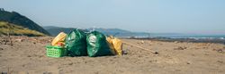 Garbage bags and utensils on the beach