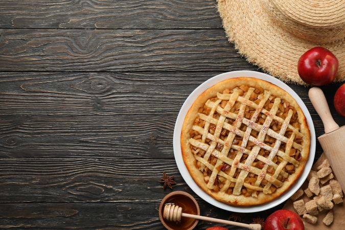 Composition with apple pie and ingredients on wooden background. Homemade food