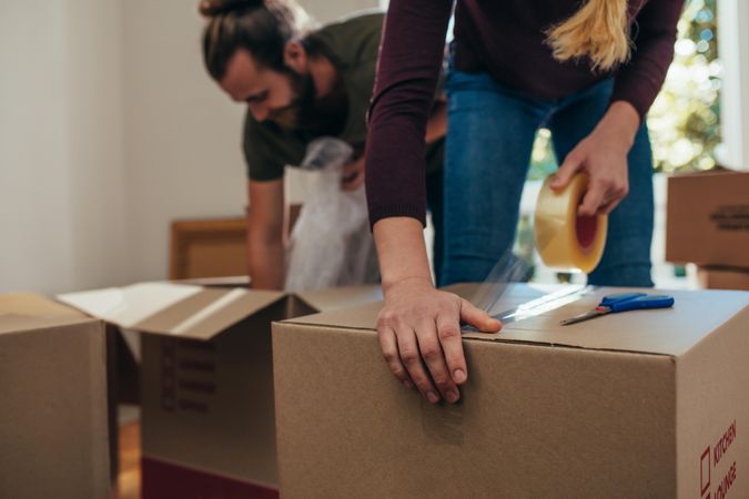Couple using packing boxes to pack their household items