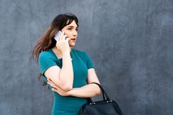 Transgender businesswoman taking a call outside