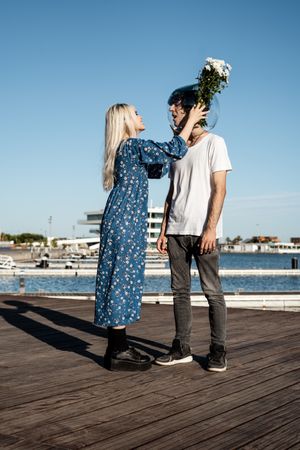 Woman helping man with fish bowl on head