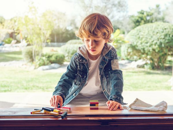 Concentrated kid playing board game