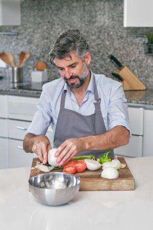 Man preparing vegetables in kitchen