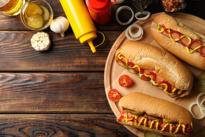 Composition with tasty hot dogs on wooden background