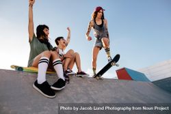 Two women cheering on their friend on s skateboard 5nnGD5