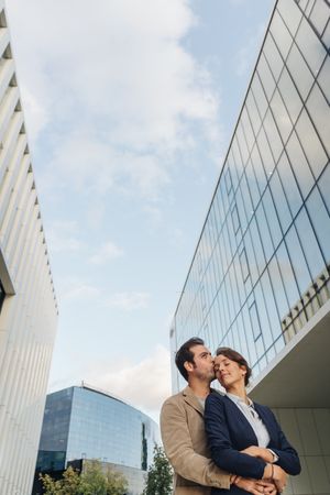 Businesspeople couple outside contemporary building