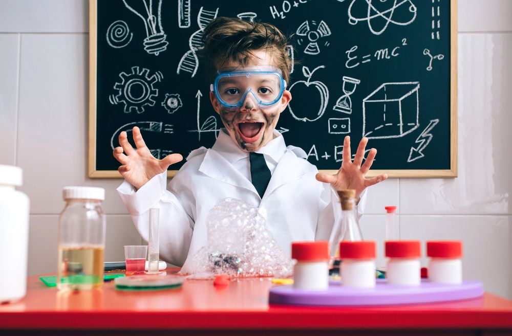 Happy little boy playing excited with experiment results