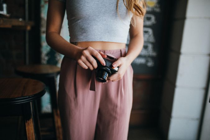 Young woman holding a camera in her hands