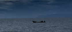 Sailing boat in dark sea