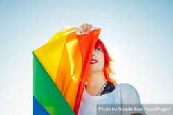 Woman with red hair holding rainbow flag 5wdyy4