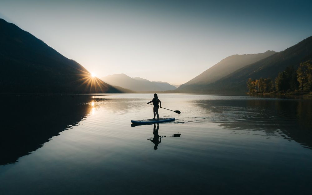 Silhouette of person riding on boat on lake
