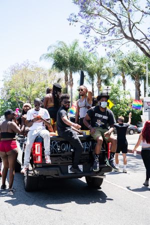 Los Angeles, CA, USA — June 14th, 2020: group of men riding in back of truck at protest rally