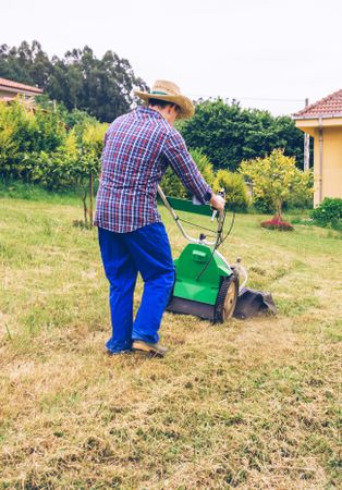 man mowing the lawn with lawnmower
