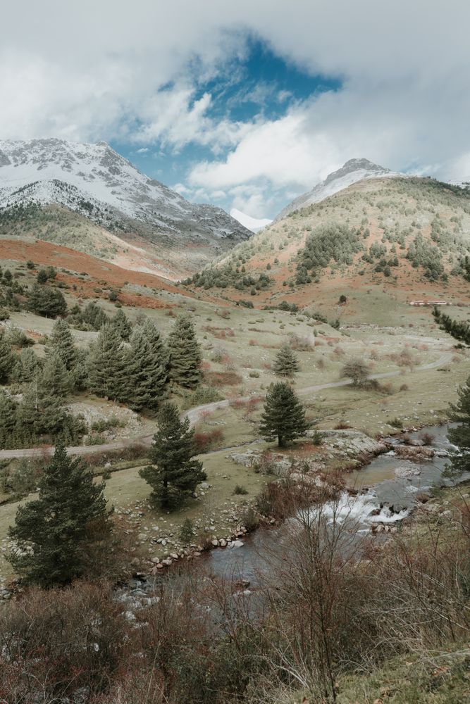 Wonderful valley with trees and high hills in cloudy weather