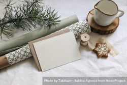Greeting card, invitation mockup with gingerbread cookies, pine tree branches on linen table cloth 0J3mv5