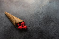 Christmas holiday concept of cone with red baubles