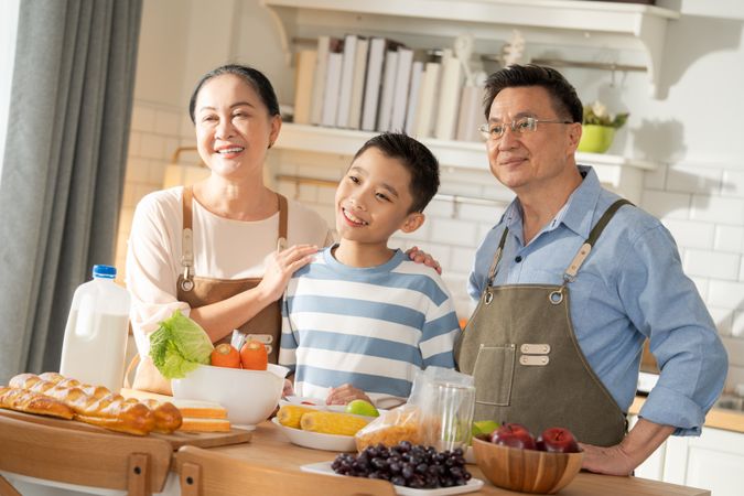Portrait of Asian family preparing food in the kitchen