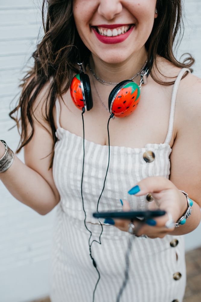 Woman with bright headphones and mobile phone