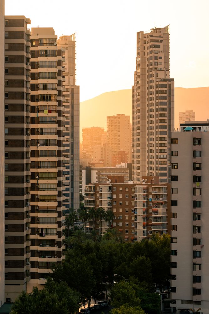 Residential buildings against sunset sky
