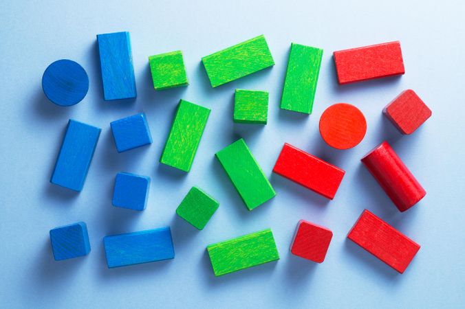 Scattered blue, green and red wooden blocks