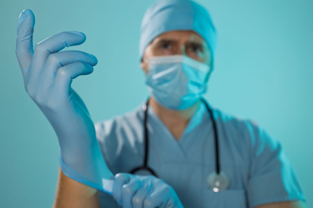 Doctor Putting On Gloves