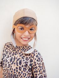 Child in leopard costume and hat with ears