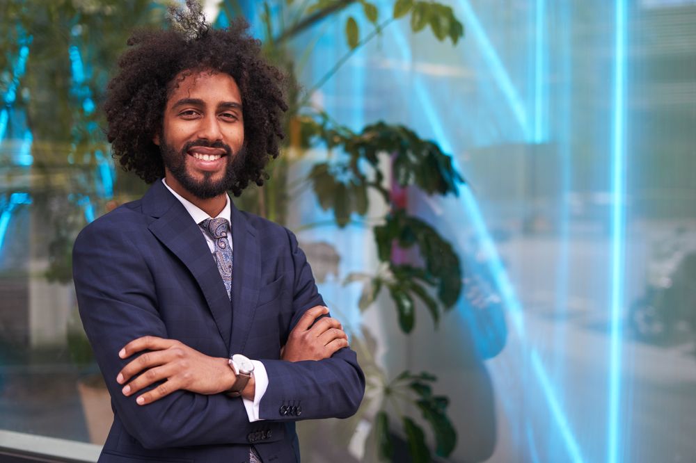 Successful Black businessman in suit smiling