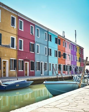Multicolored building beside water canal and gondola