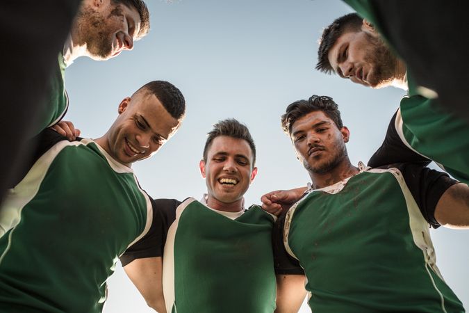 Low angle view of rugby players standing against clear sky