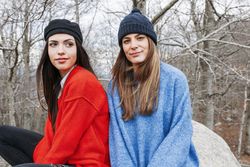 Smiling women in sweaters in park