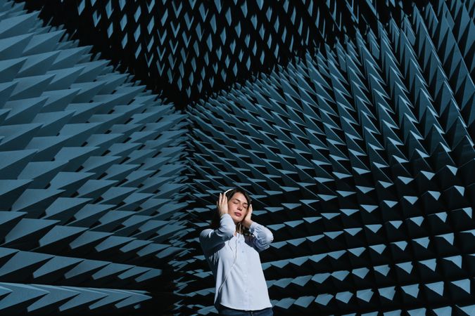 Woman in sound room listening to music