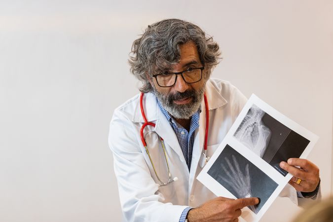 Doctor discussing x ray with colleagues in hospital