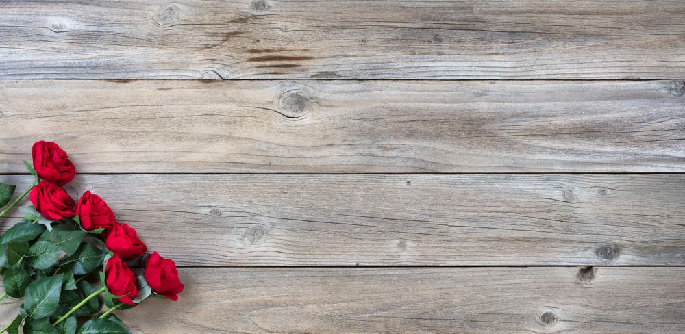 Six traditional red roses on rustic wood