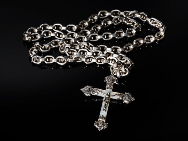 Catholic cross made of silver and mother-of-pearl. Antique jewelry.