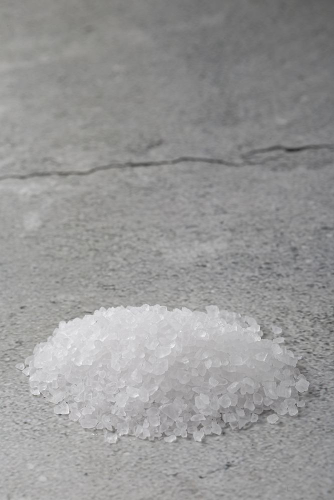 Handful of coarse salt on the table.