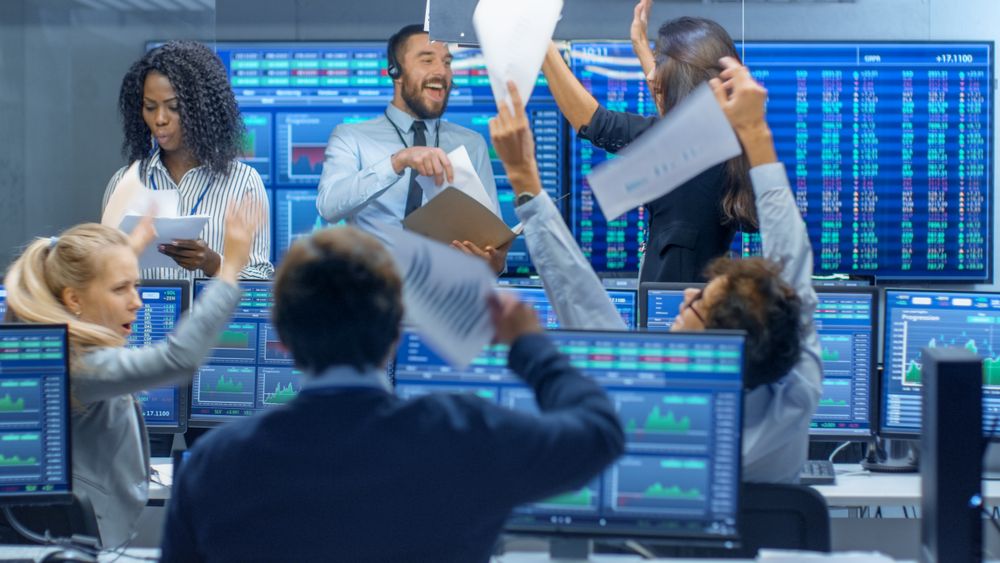Multi-Ethnic Team of Traders Have Successful Day at the Stock Exchange Office.